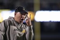 Appalachian State coach Shawn Clark gestures during the first half of the team's NCAA college football game against Coastal Carolina on Wednesday, Oct. 20, 2021, in Boone, N.C. (AP Photo/Matt Kelley)