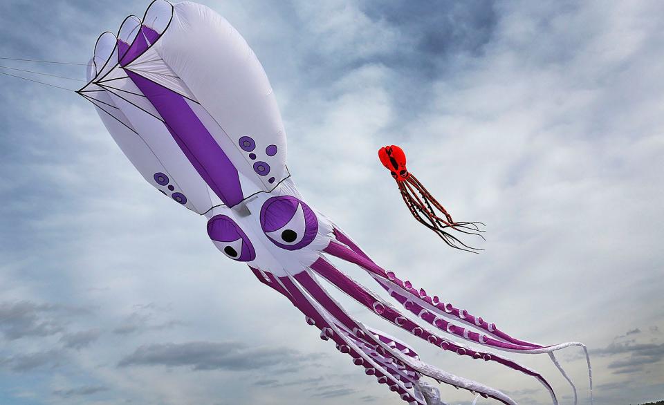 John Herr, of Rockland, flies 60-foot-long octopus kites at Union Point in South Weymouth on Thursday, Jan. 6, 2022. He uses an anchor point to hold the strings, which were once used to tie down U.S. Navy aircraft at the closed air base.