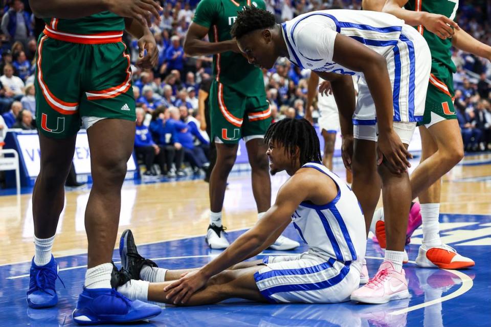 Kentucky guard D.J. Wagner holds his leg after being fouled by Miami’s Wooga Poplar during an ACC/SEC Challenge game at Rupp Arena on Nov. 28. Wagner injured his left ankle on the play.