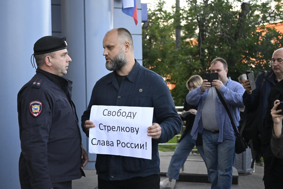 Pavel Gubarev, an activist of the "Club of Angry Patriots" nationalist group, pickets outside the Meshchansky Court with a poster reading "Freedom to Strelkov, Glory to Russia!" during a hearing on the pre-trial arrest of Igor Strelkov, a retired security officer who led Moscow-backed separatists in eastern Ukraine in 2014, in Moscow, Russia, Friday, July 21, 2023. (Alexander Nemenov/Pool Photo via AP)