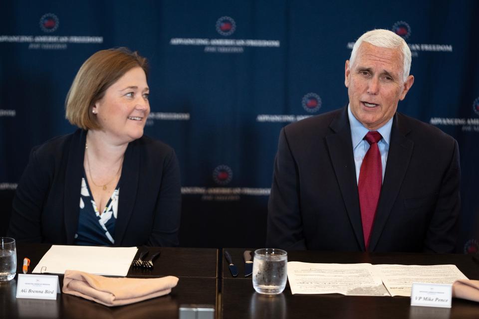 Former Vice President Mike Pence, accompanied by Iowa Attorney General Brenna Bird, gives opening remarks before a roundtable discussion about parental choice, on Wednesday, May 24, 2023, in Des Moines. 