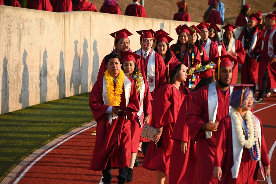 Students earning degrees at Pasadena City College participate in the graduation ceremony, June 14, 2019, in Pasadena, California. - With 45 million borrowers owing $1.5 trillion, the student debt crisis in the United States has exploded in recent years and has become a key electoral issue in the run-up to the 2020 presidential elections. "Somebody who graduates from a public university this year is expected to have over $35,000 in student loan debt on average," said Cody Hounanian, program director of Student Debt Crisis, a California NGO that assists students and is fighting for reforms. (Photo by Robyn Beck / AFP)        (Photo credit should read ROBYN BECK/AFP/Getty Images)