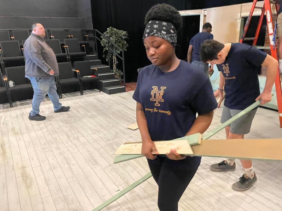 Norwich Tech freshman Genaele Polo helping with stage maintenance at the Chestnut Street Playhouse during the school's Community Day Friday.