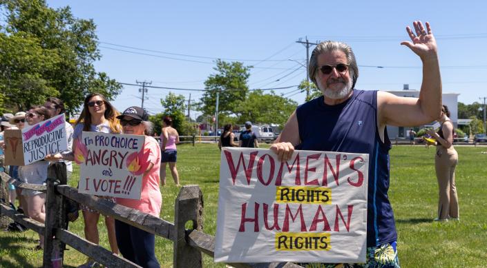 Rich Falzone, 67, who is holding a sign “Women’s Rights, Human Rights” at the Hyannis rotary on Saturday, He was on hand to protest the Supreme Court's decision to overturn Roe v. Wade, the ruling that legalized abortion.  “It’s a sad day, I have two daughters, one is nine months pregnant and they should have to choice,&quot; he said.