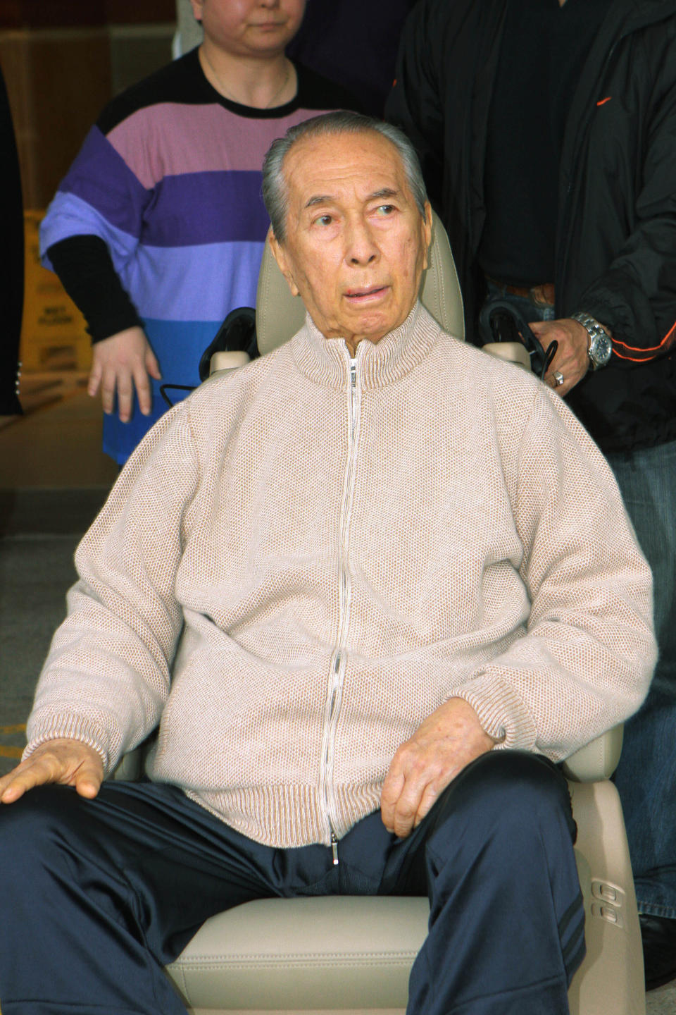 In this March 6, 2010, file photo, casino mogul Stanley Ho, wearing casual clothes and sneakers, is wheeled out of a Hong Kong hospital. On Tuesday, May 26, 2020, the family of Stanley Ho, the Macao casino tycoon considered the father of modern gambling in China, has died at 98. (AP Photo, File)