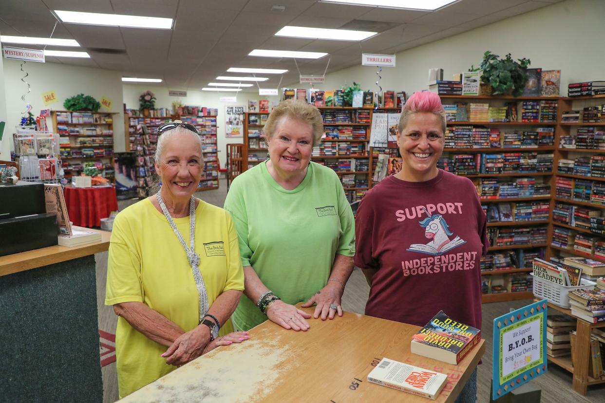 From left, Linda Gray, Holly Escobedo and Tracy Blackburn work at the Book Rack used book store in La Quinta, Calif., June 16, 2022.