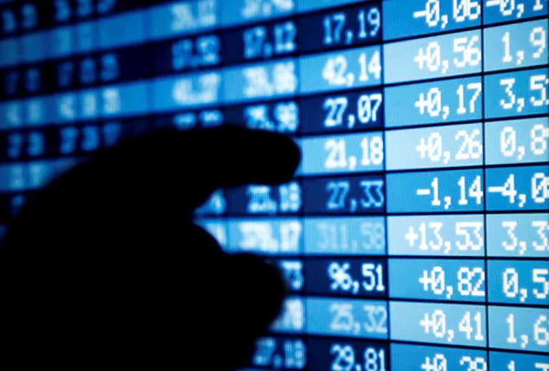 FILE PHOTO: A man points a computer screen showing stock information in this illustration photo taken in Bordeaux