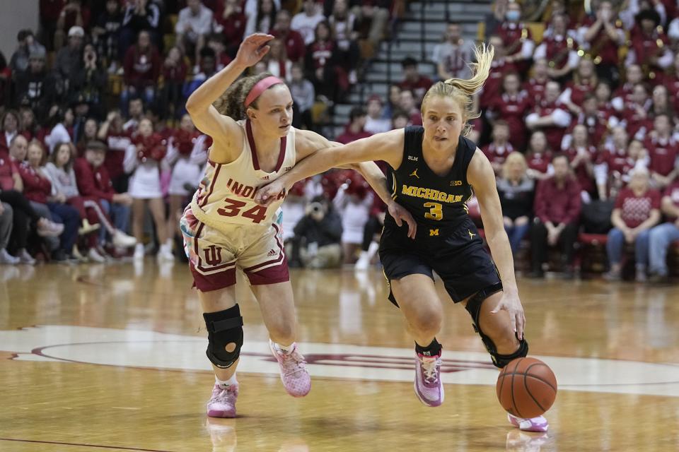 Michigan guard Maddie Nolan (3) drives against Indiana guard Grace Berger (34) during the first half of an NCAA college basketball game Thursday, Feb. 16, 2023, in Bloomington, Ind. (AP Photo/Darron Cummings)