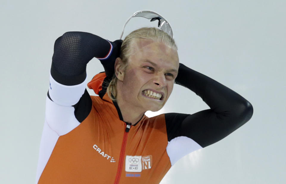 Silver medalist Koen Verweij of the Netherlands grabs his hair when the race was declared a tie with gold medalist Poland's Zbigniew Brodka in the men's 1,500-meter speedskating race at the Adler Arena Skating Center during the 2014 Winter Olympics in Sochi, Russia, Saturday, Feb. 15, 2014. Verweij later was later declared silver, losing by three thousandth of a second. (AP Photo/Matt Dunham)