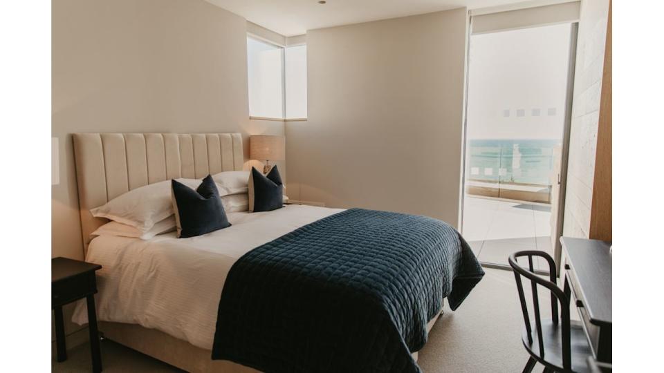 Blue lodge bedroom at Clifftops on Pennsylvania Castle Estate