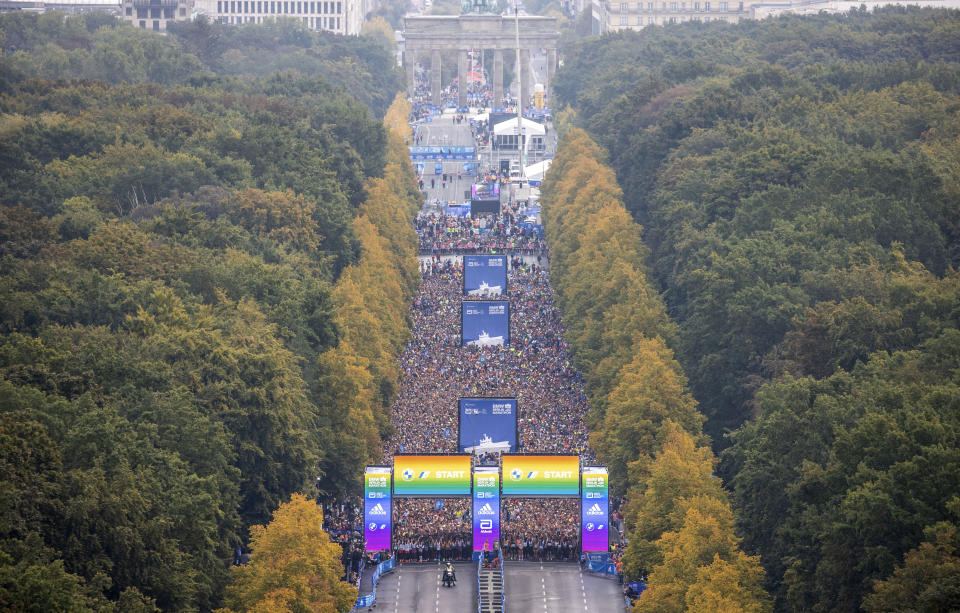 Runners of the first wave line up on the street of June 17 for the start of the Berlin Marathon, in Berlin, Sunday, Sept. 25, 2022. (Andreas Gora/dpa via AP)