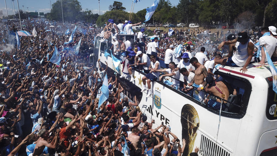 Soccer fans welcome home the Argentine soccer team after it won the World Cup tournament in Buenos Aires, Argentina, Tuesday, Dec. 20, 2022. (AP Photo/Victor Caivano)