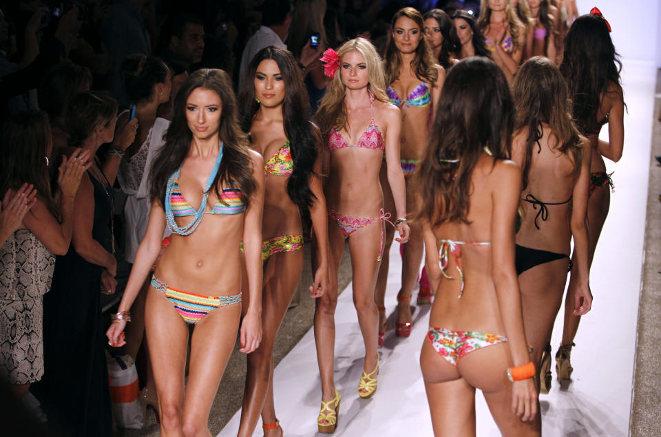 Models wear swimwear from the collection of Luli Fama during the Mercedes-Benz Fashion Week Swim 2013 show, Sunday, July 22, 2012, in Miami Beach, Fla. (AP Photo/Lynne Sladky)