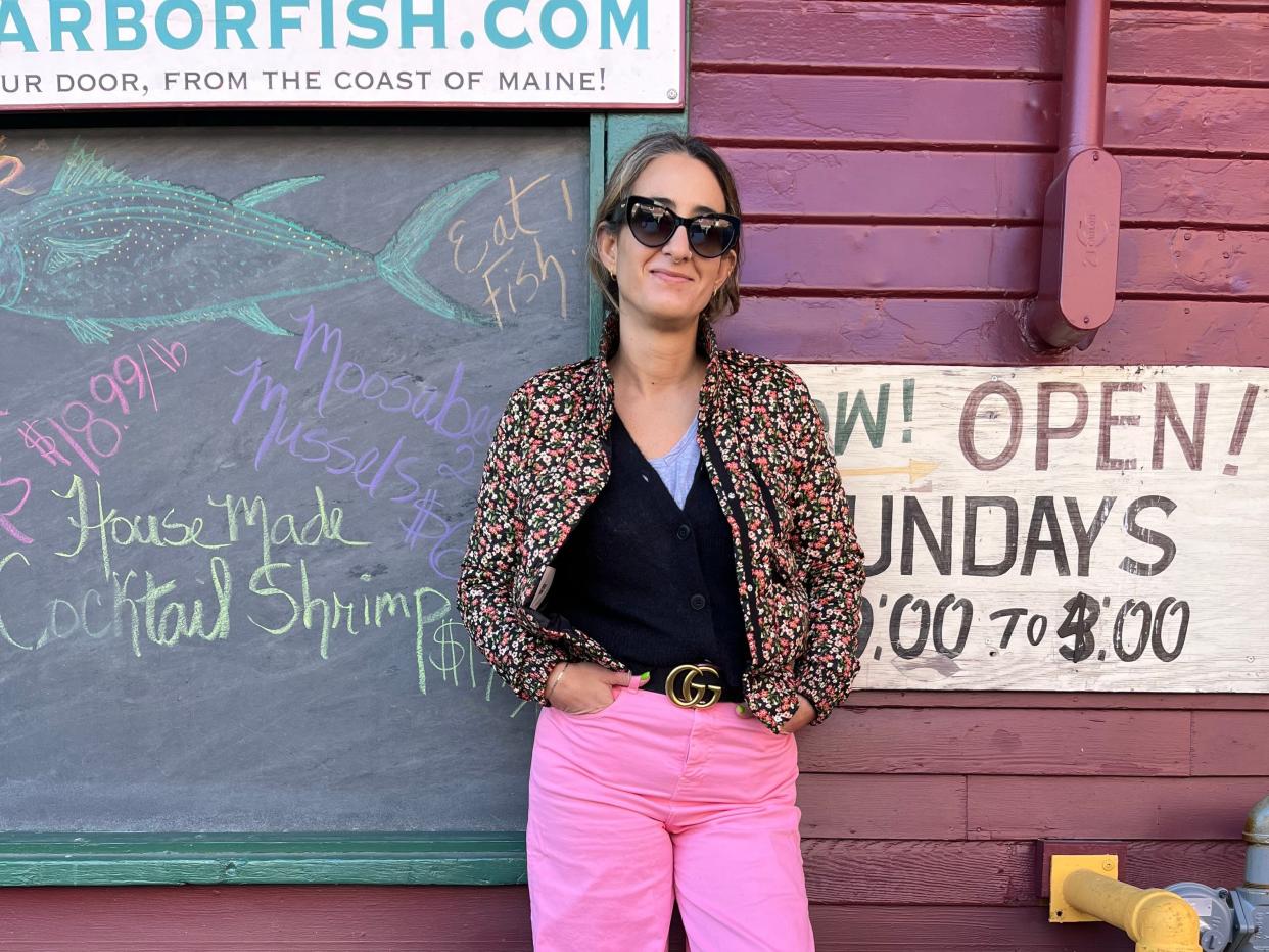 Woman posing for photo by wall