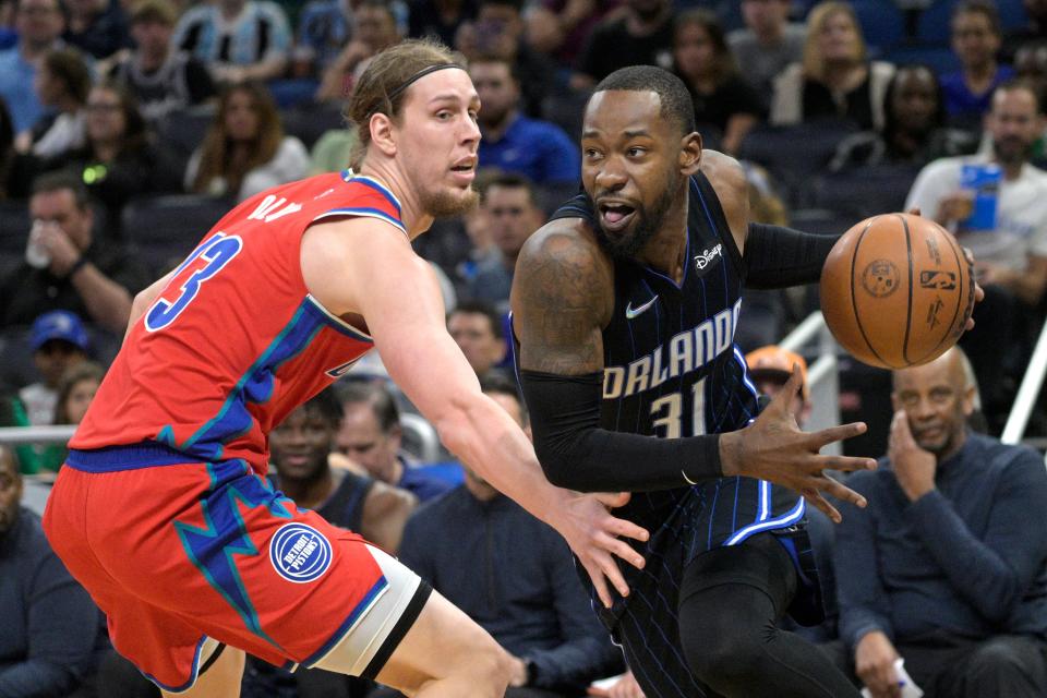 Orlando Magic guard Terrence Ross (31) drives to the basket past Detroit Pistons forward Kelly Olynyk (13) during the first half of an NBA basketball game on Thursday, March 17, 2022, in Orlando, Fla.