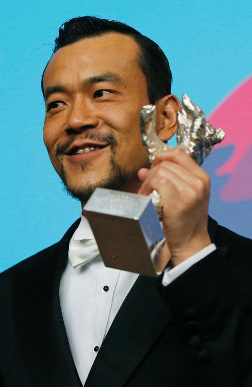 Actor Liao Fan holds his Silver Bear award for Best Actor at the Berlin film festival on February 15, 2014