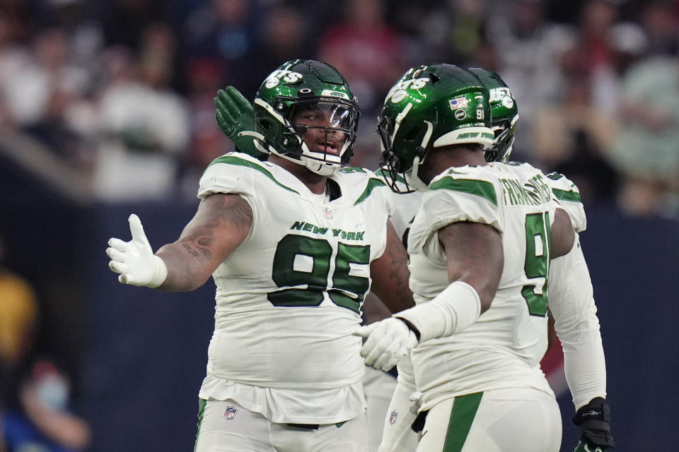 New York Jets defensive tackle Quinnen Williams (95) and defensive end John Franklin-Myers celebrate in the second half of an NFL football game in Houston, Sunday, Nov. 28, 2021. The Jets won 21-14. (AP Photo/Eric Smith)