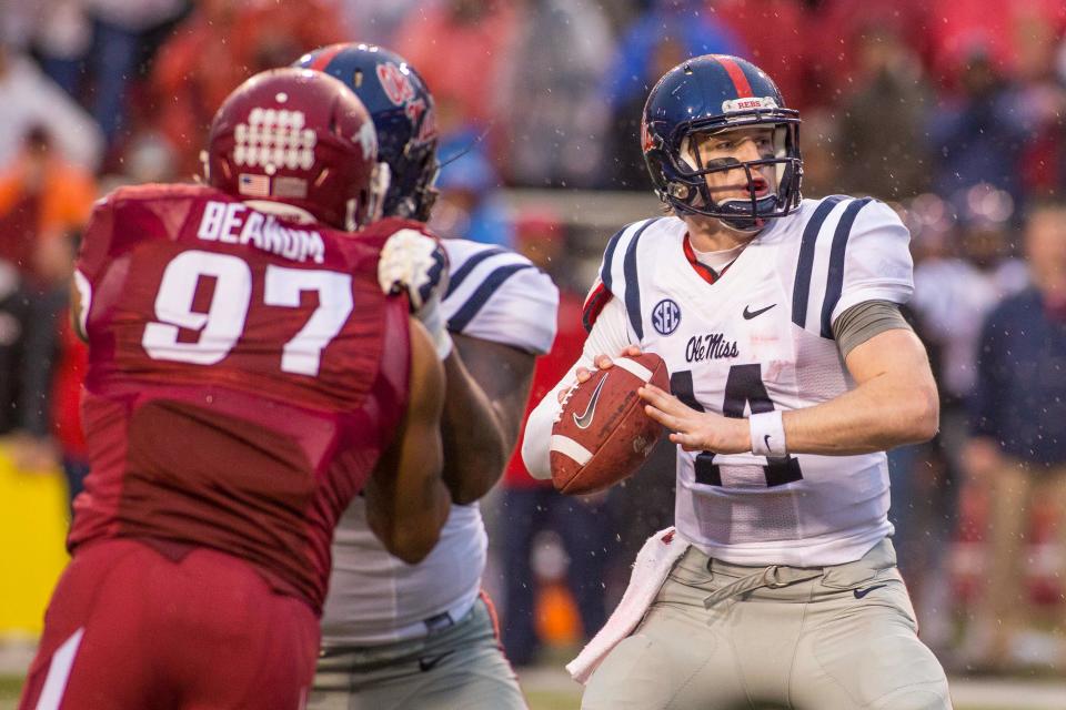 Nov 22, 2014; Fayetteville, AR, USA; Ole Miss Rebels quarterback Bo Wallace (14) looks to pass as offensive lineman Fahn Cooper (74) blocks Arkansas Razorbacks defensive end Tevin Beanum (97) during first half action at Donald W. Reynolds Razorback Stadium. Mandatory Credit: Beth Hall-USA TODAY Sports