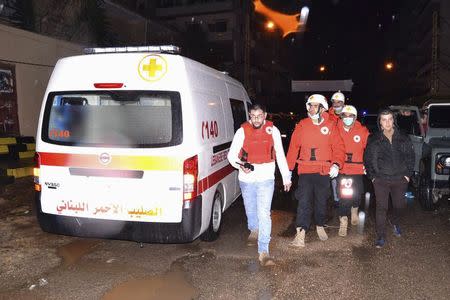 Lebanese Red Cross members walk in an area beside a cafe where a suicide bomb attack took place in Jabal Mohsen, Tripoli January 10, 2015. REUTERS/Stringer