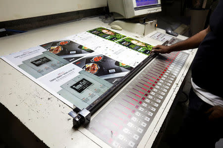 An employee works on a print out of the "Time Out Ramallah", a special edition of the Time Out magazine, marking 50 years since Israel's occupation of the West Bank and Gaza Strip, at a printing house in Yavne, near Tel Aviv, Israel October 25, 2017. REUTERS/Nir Elias