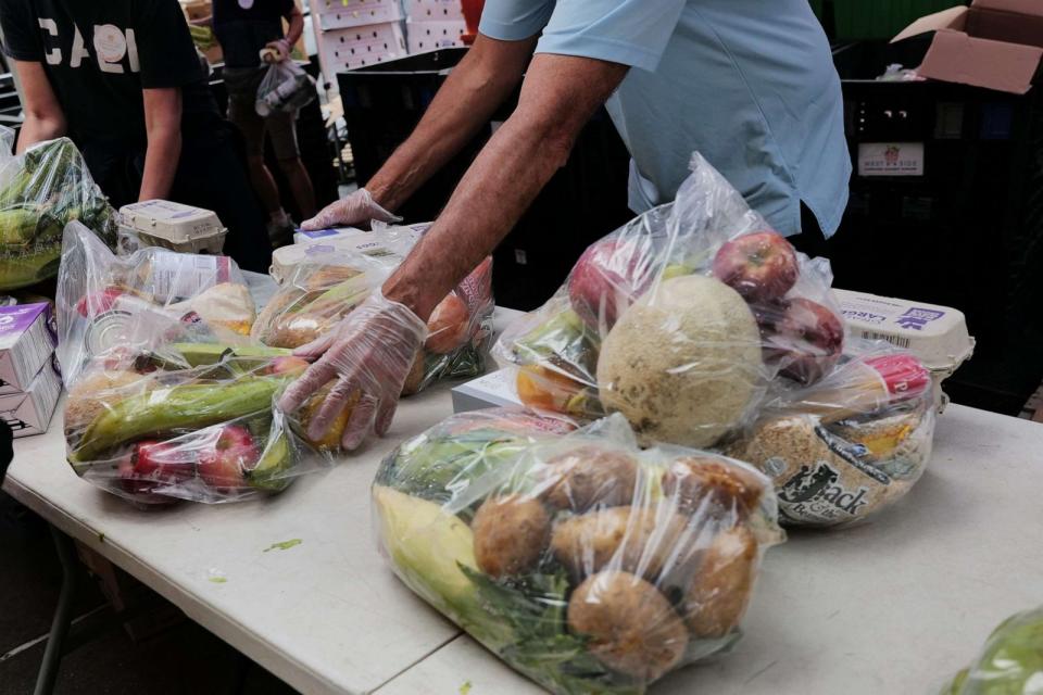 PHOTO: Volunteers and employees with West Side Campaign Against Hunger (WSCAH) distribute food to those in need outside of their Manhattan facility on Aug. 17, 2023 in New York City. (Spencer Platt/Getty Images)