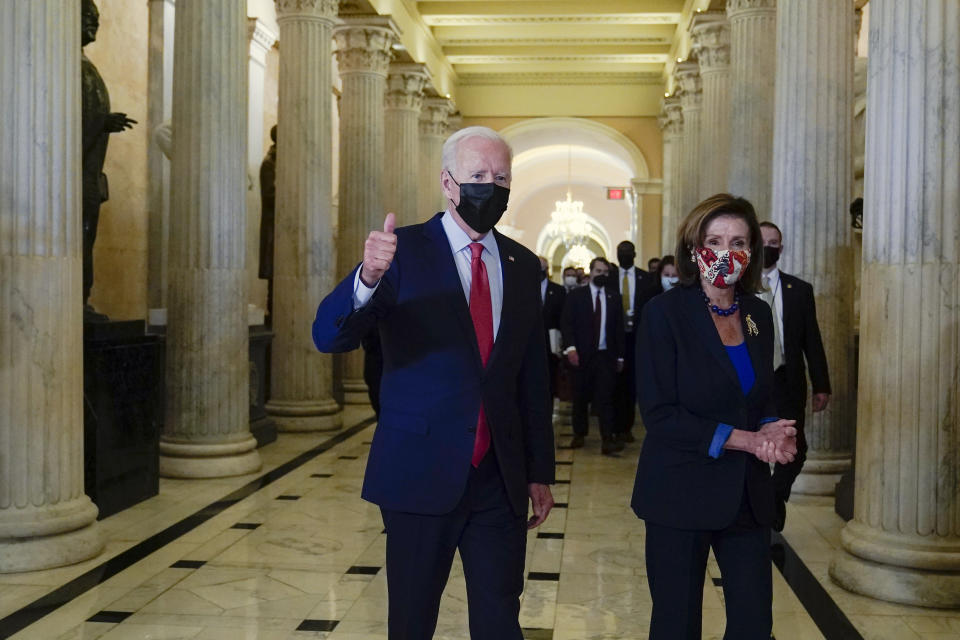 President Joe Biden gives a thumbs up as he walks with House Speaker Nancy Pelosi of Calif., on Capitol Hill in Washington, Friday, Oct. 1, 2021, after attending a meeting with the House Democratic caucus to try to resolve an impasse around the bipartisan infrastructure bill. (AP Photo/Susan Walsh)