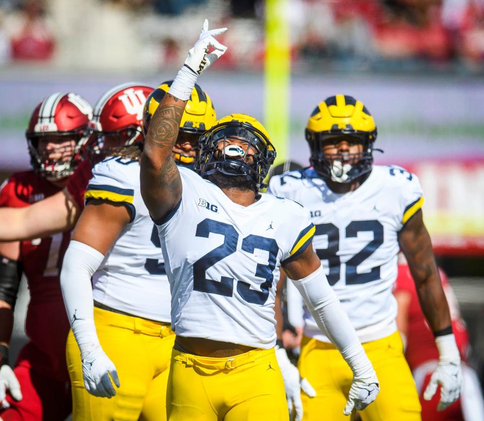 Michigan's Michael Barrett (23) celebrates his sack of Indiana's Connor Bazelak (not pictured) during the Indiana versus Michigan football game at Memorial Stadium on Saturday, Oct. 8, 2022.