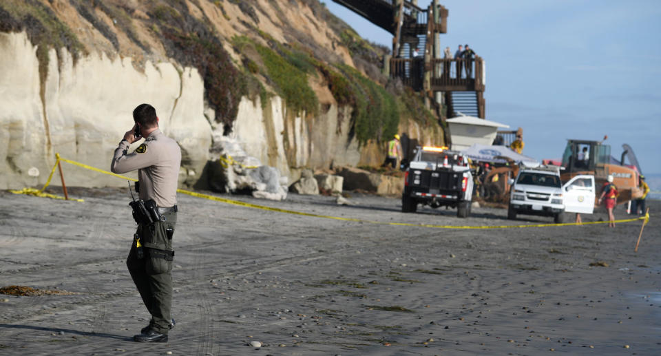 Emergency crews are shown at California's Grandview Beach after a bluff crushed and killed three people. 