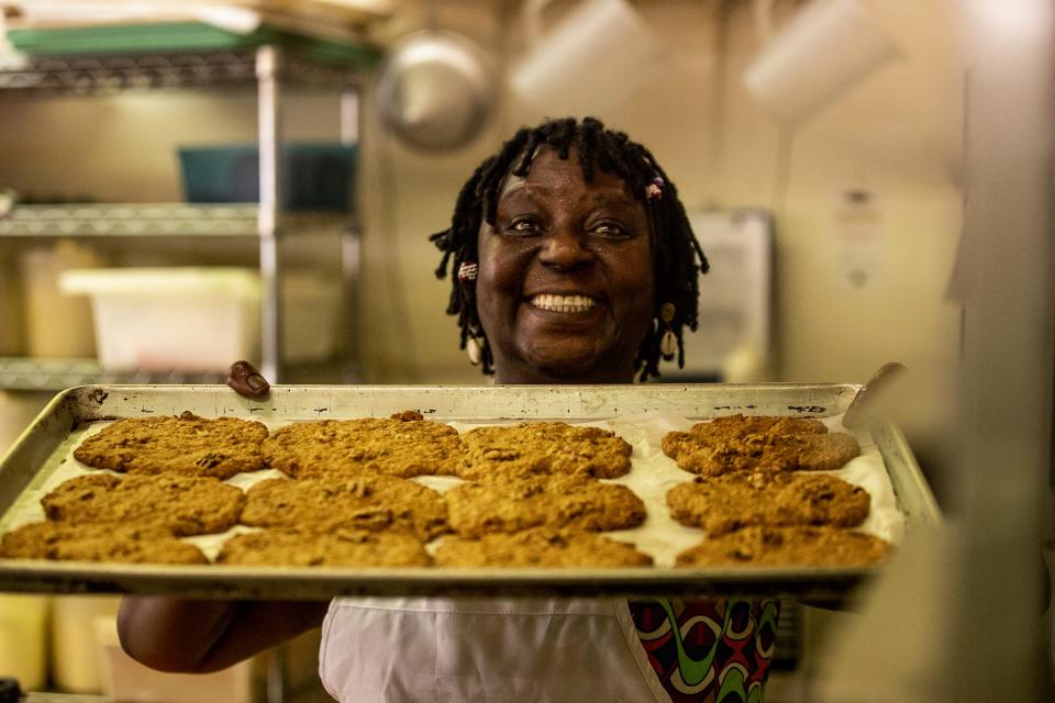 Elizabeth Kizito is happy to show off a fresh batch of oatmeal cookies. Aug. 1, 2019