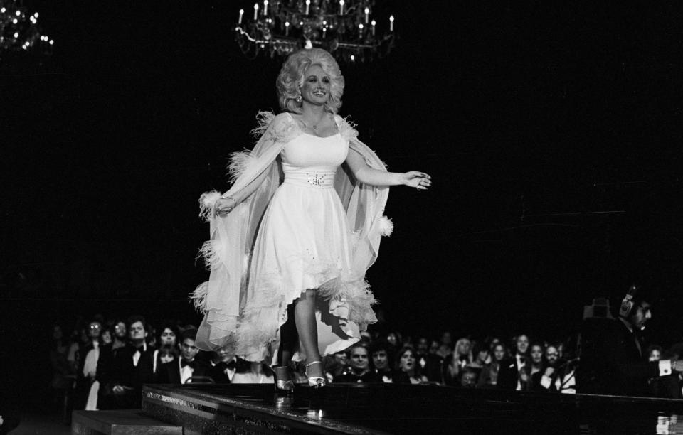 Singer/songwriter/actor Dolly Parton walks to the microphone during the taping of 3rd Annual Rock Awards TV show at the Palladium, Hollywood, CA 1977. (Photo by Mark Sullivan/Getty Images)