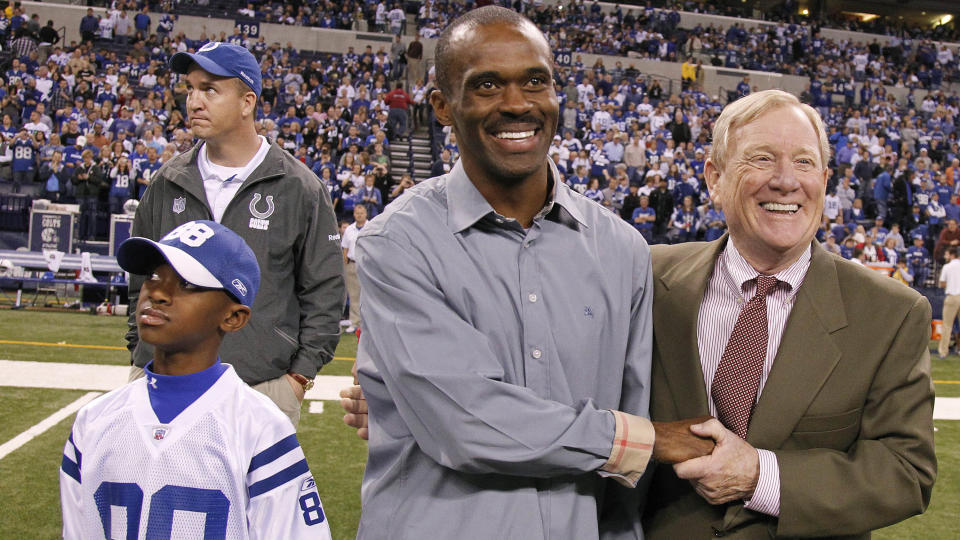 Former Colt Marvin Harrison is honored at halftime in 2011 with former <a class="link " href="https://sports.yahoo.com/nfl/teams/indianapolis/" data-i13n="sec:content-canvas;subsec:anchor_text;elm:context_link" data-ylk="slk:Colts;sec:content-canvas;subsec:anchor_text;elm:context_link;itc:0">Colts</a> Vice Chairman Bill Polian, his son Marvin Harrison Jr. and former Colt Peyton Manning on Nov. 27, 2011, in Indianapolis. (Sam Riche/Tribune News Service via Getty Images)