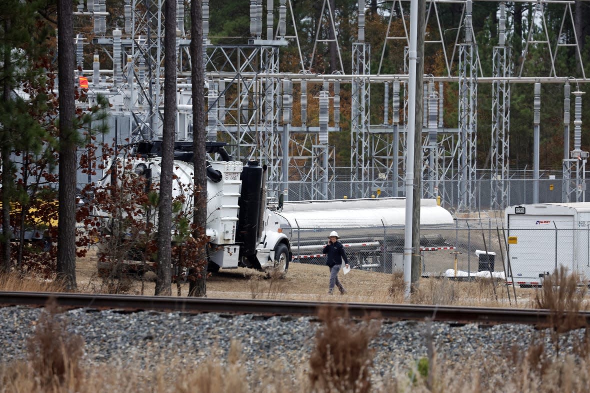 Workers work on equipment at the West End Substation, at 6910 NC Hwy 211 in West End, N.C., Dec. 5, 2022, where a serious attack on critical infrastructure has caused a power outage to many people around Southern Pines, N.C. (AP Photo/Karl B DeBlaker, File)