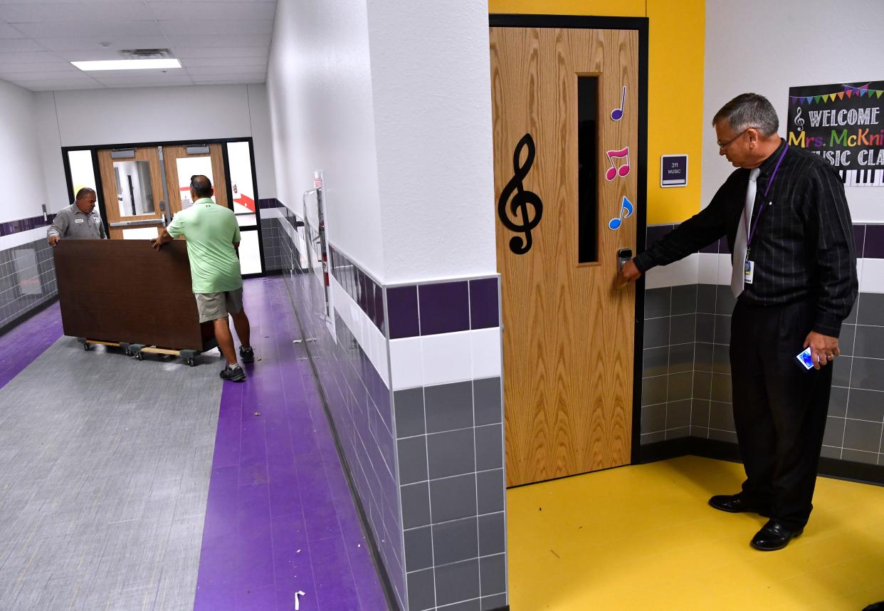Wylie ISD Superintendent Joey Light checks a classroom door as staff members wheel furniture down a hallway at Wylie East Elementary School a few days before the campus first opened in August 2021. The district is asking voters again to pass a series of bond measures on Nov. 7, one of which will fund the building of another elementary school as well as add 63 classrooms to Wylie High School.