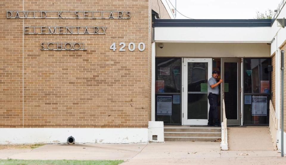 A security guard with Fort Worth ISD stands at the door of David K. Sellers Elementary School on Wednesday, October 11, 2023. A staff member was fatally shot in the back parking Wednesday morning.