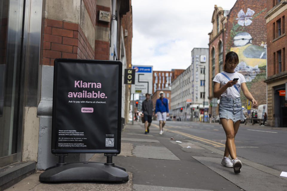 Members of the public pass by a floor advertisement for tech firm Klarna, an ecommerce company which allows users to buy now, pay later, or pay in installments. (Credit: Daniel Harvey Gonzalez/In Pictures via Getty Images)