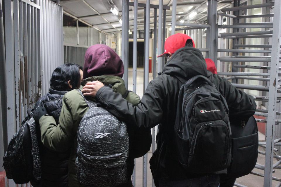 A family from Michoacán, Mexico, stands in front of the Dennis DeConcini Port of Entry in Nogales, Sonora, Mexico, before attending their appointment to request an exemption from Title 42 on Jan. 21, 2023.