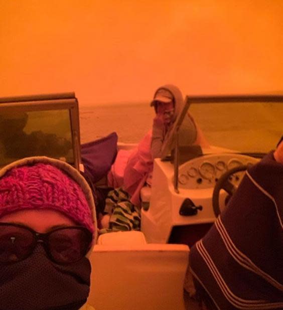 People take shelter on a boat just offshore as bushfires rage in the area around Mallacoota (Courtesy of Ida Dempsey/AFP)