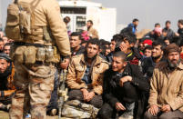 Displaced Iraqis wait for checks by Iraqi forces in western Mosul, Iraq March 24, 2017. REUTERS/Suhaib Salem