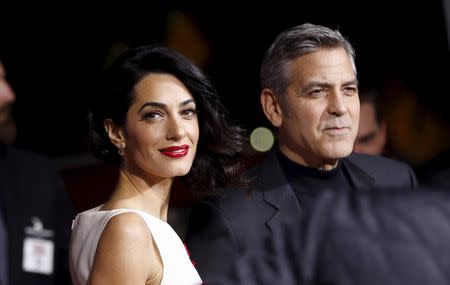 Cast member George Clooney and his wife Amal pose at the premiere of "Hail, Caesar!" in Los Angeles, California February 1, 2016. The movie opens in the U.S. on February 5. REUTERS/Mario Anzuoni