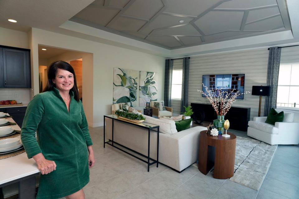 Sales specialist Tina Lee of Jones Homes USA shows off one of the builder's model homes at Legends Preserve in Daytona Beach, Monday, March 11, 2024.