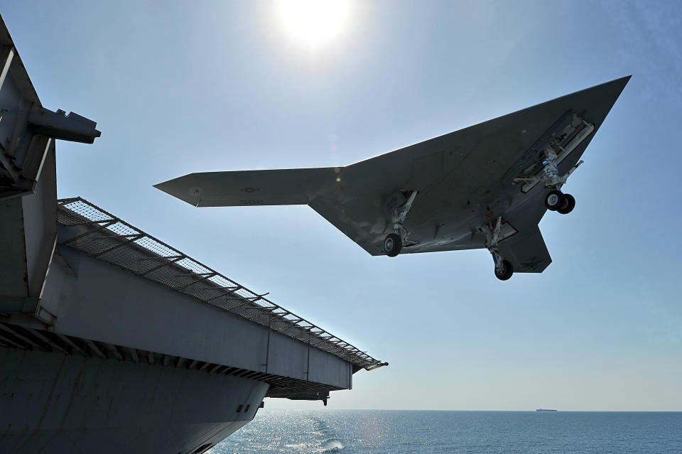 ATLANTIC OCEAN - MAY 17: In this image provided by the U.S. Navy, an X-47B unmanned combat air system (UCAS) demonstrator performs a touch and go landing May 17, 2013 on the flight deck of the aircraft carrier USS George H.W. Bush (CVN 77) in the Atlantic Ocean. This is the first time any unmanned aircraft has completed a touch and go landing at sea. George H.W. Bush is conducting training operations in the Atlantic Ocean. (Photo by Mass Communication Specialist 2nd Class Timothy Walter/U.S. Navy via Getty Images)