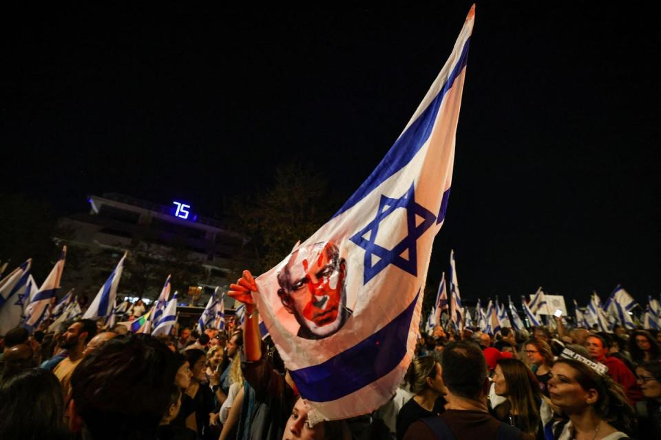 Israeli demonstrators protest against the government in Jerusalem on Sunday night (AFP via Getty Images)