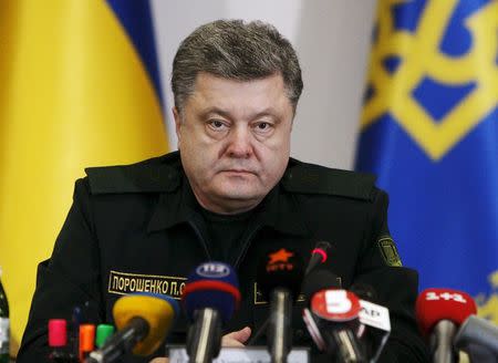 Ukraine's President Petro Poroshenko talks to military staff in Kiev in this February 14, 2015 file photo. REUTERS/Valentyn Ogirenko/Files