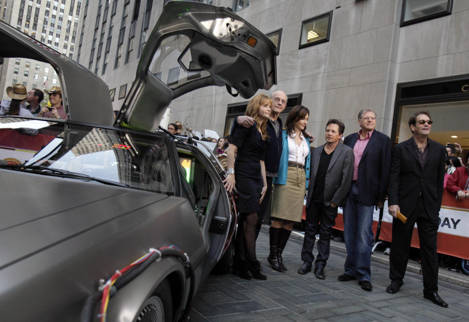 Cast members of the "Back to the Future" movies appear on the NBC "Today" television program, commemorating the 25th anniversary of the films, in New York Tuesday, Oct. 26, 2010. They are, from left, posing with a replica of the DeLorean car, Lea Thompson, Christopher Lloyd, Mary Steenburgen, Michael J. Fox, director Robert Zemeckis , and Huey Lewis.  (AP Photo/Richard Drew)