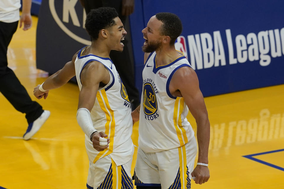 Golden State Warriors guard Stephen Curry, right, celebrates with guard Jordan Poole during the second half of an NBA basketball game against the Memphis Grizzlies in San Francisco, Sunday, May 16, 2021. (AP Photo/Jeff Chiu)