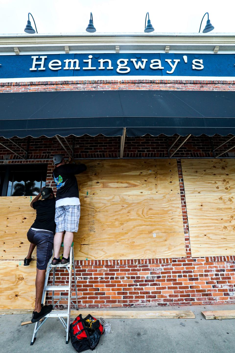 Travis Winesett, chef, and Stephan Breton, sous chef, put up plywood on the front windows of the restaurant Hemingway's in downtown Punta Gorda. They were closed on Monday so it was a good time to get the restaurant prepared. The men were all here for Charley and had a "let's hope this is all for nothing" attitude. As Hurricane Ian tracks closer and closer to Punta Gorda are residents feeling like this storm will be another Charley? Monday, September 26, 2022. 