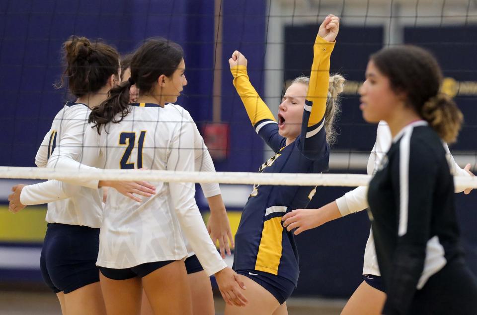 Copley's Kayla Kemer, center, celebrates with her teammates during the second set of a volleyball match against Cuyahoga Falls, Tuesday, Sept. 6, 2022, in Copley, Ohio.