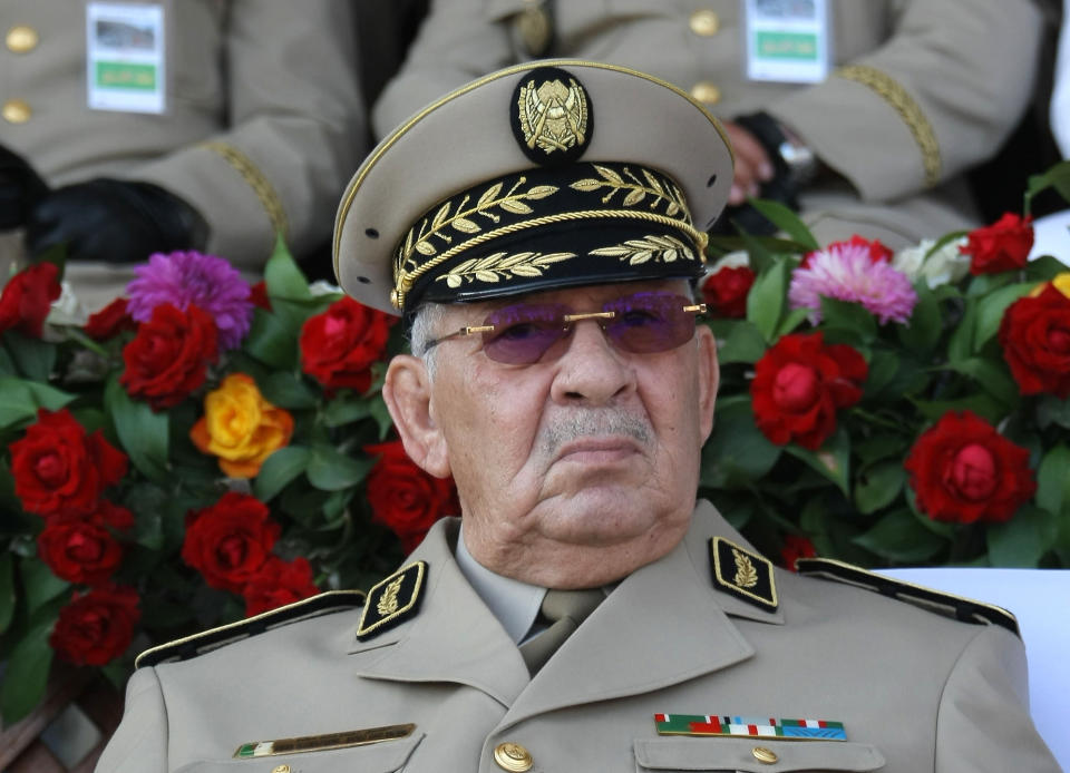 FILE - In this Sunday, July 1, 2018 file picture Algerian chief of staff Gen. Ahmed Gaid Salah presides a military parade in Algiers. The head of Algeria's army addressed during a visit to a military school outside the capital the waves of protests shaking the country for the first time Tuesday March 5, 2019, darkly evoking the years of bloodshed before the current government took power. (AP Photo/Anis Belghoul, File)