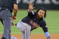 Cleveland Guardians' José Ramírez signals to the umpire after stealing second base during the seventh inning of a baseball game against the Texas Rangers, Monday, May 13, 2024, in Arlington, Texas. (AP Photo/Gareth Patterson)