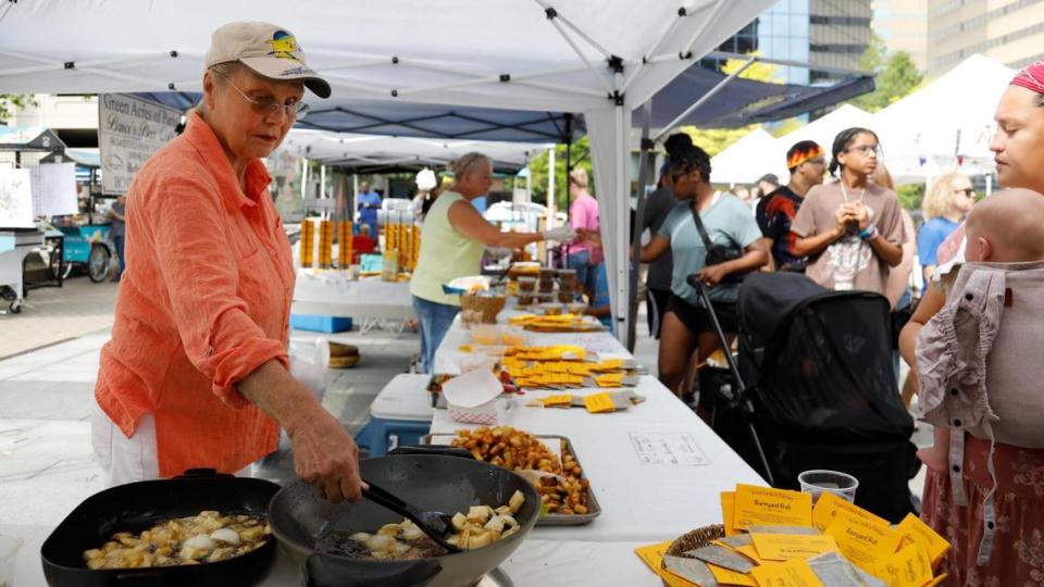 Linda Johnson cooks potatoes on Saturday, June 24, 2023 at Fifth Third Pavilion in Lexington, Ky. The market has expanded to allow vendors to cook and serve fresh food to customers.